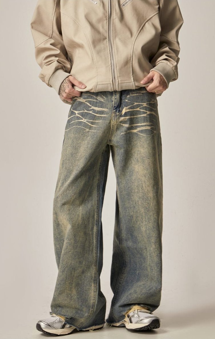 WASHED DENIM JEANS WITH DISTRESSED DETAILS