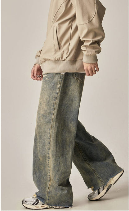 WASHED DENIM JEANS WITH DISTRESSED DETAILS